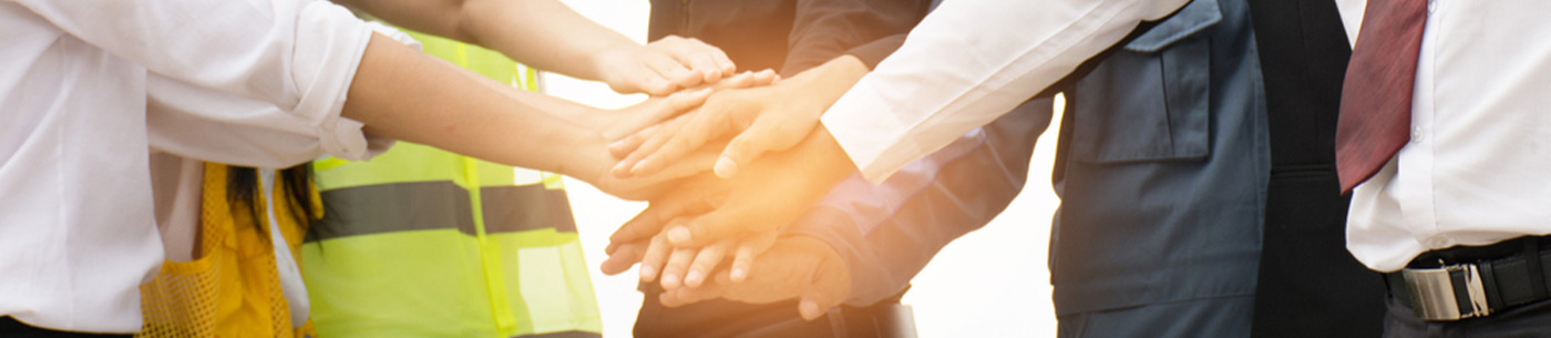 various professionals laying hands together